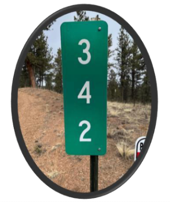 Green reflective address sign with white numbers